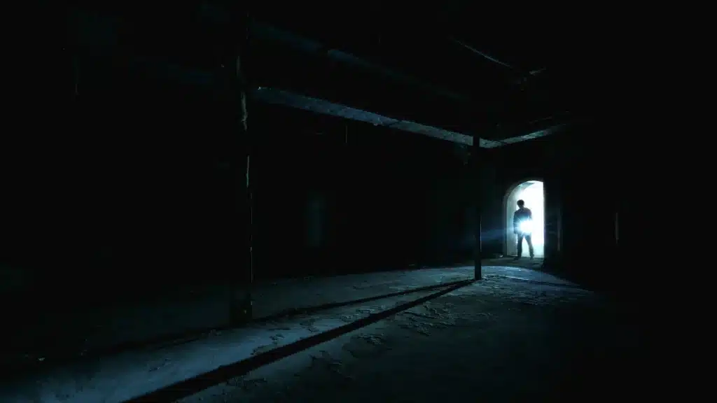 Dimly lit stairwell in a New York City building showing a poor lighting hazard that can cause trips and falls